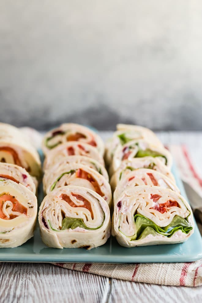 Turkey Rollups on a blue serving platter. 